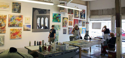 Inside the Miller School of Art studio, easels and finished paintings on the wall