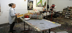 Two students working side by side on their canvases